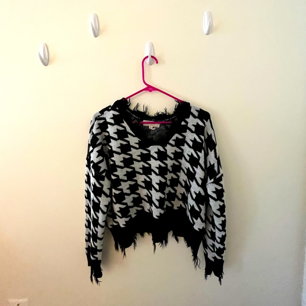 Black and white sweater . Size medium . Cropped. Hardly used. 100% acrylic .